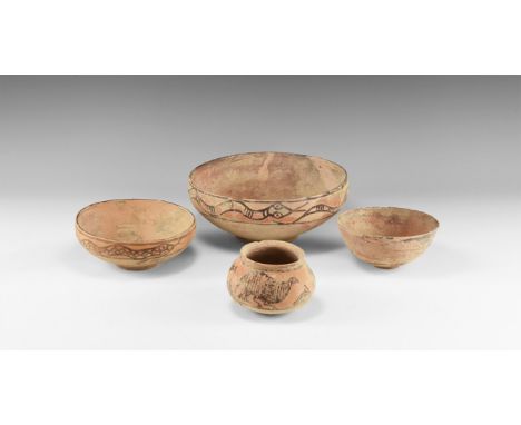 3rd-2nd millennium BC. A mixed terracotta group comprising: two bowls each with serpents to the rim; a hemispherical bowl wit