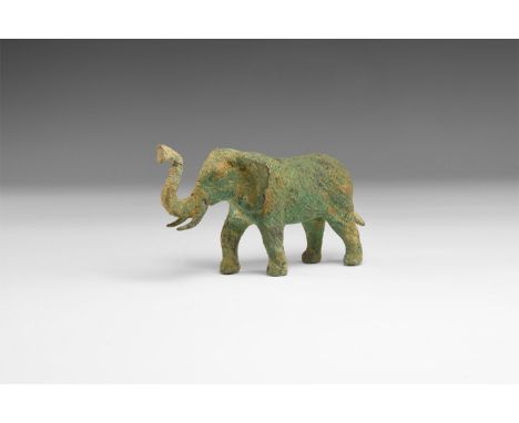 An undated archaistic cast copper alloy elephant figure with raised trunk, cross-hatching to simulate skin texture.   215 gra