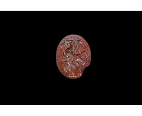 1st-2nd century AD. A bloodstone intaglio engraved with a Gyrillos monster composed of a human head with horse and bird head 