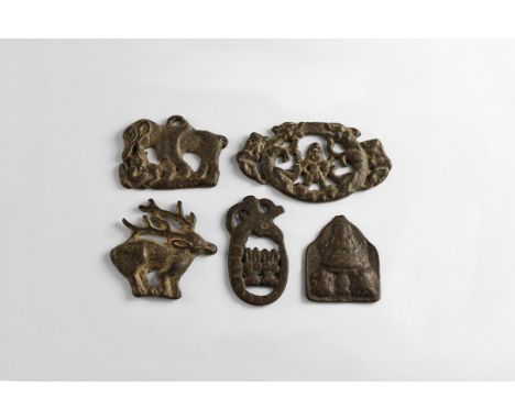 A group of five undated archaistic bronze plaques consisting of: a standing stag; a feline attcking a smaller animal; a ibex 