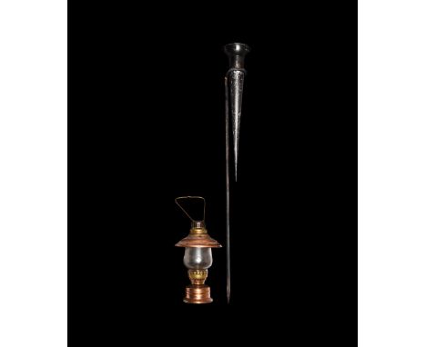 20th century AD. A mixed group comprising: a copper and brass oil lamp with suspension loop; a garden oil lamp with wick and 