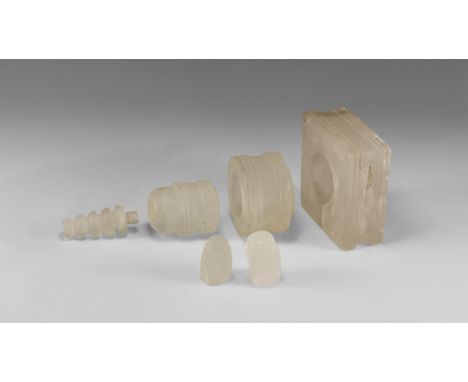 20th century AD. A mixed group of rock crystal items comprising: a square plinth base with hemispherical socket; a columnar s