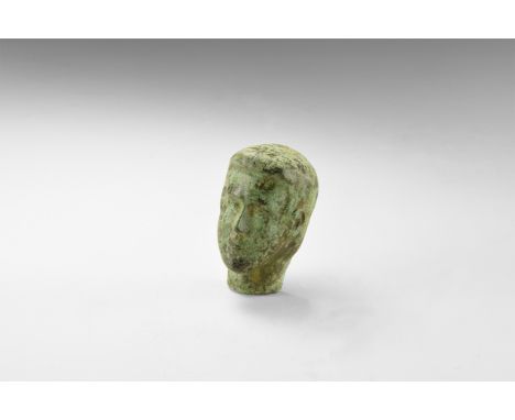 An undated archaistic bronze mask with youthful features and short hair; hollow to the reverse.   83 grams, 69mm (2 3/4"). Pr