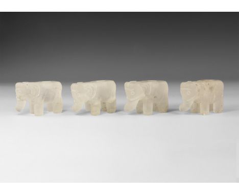 20th century AD. A group of quartz elephants with flat tops and a hole to the centre; carved details to the face and trunk.  