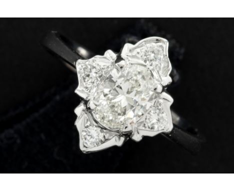 vintage ring in white gold (18 carat) with a 0,60 carat high quality oval brilliant cut diamond surrounded by ca 0,20 carat o