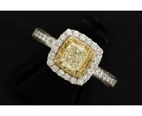 a 1,02 carat fancy light yellow color quality brilliant cut diamond set in a ring in white gold (18 carat) with ca 1,30 carat