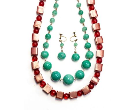 An Art Deco red lucite bead necklace, cubes and spheres, together with a jade style graduated bead necklace and earrings