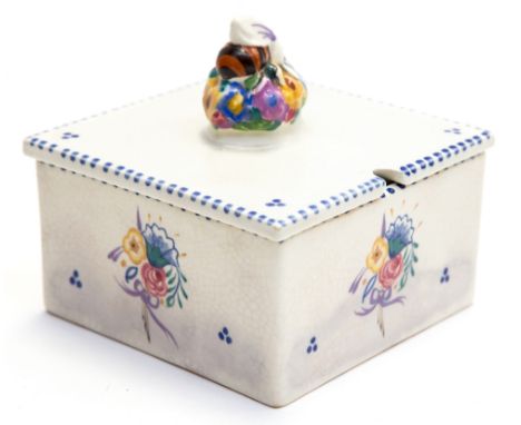 A Poole Pottery honey box and cover, circa 1930, the finial modelled as a honey bee on bouquet of flowers, decorated with dot
