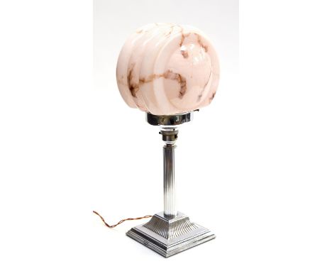 An Art Deco chrome and glass table lamp, the pink marbled shade of circular ribbed form supported on a Classical column base,