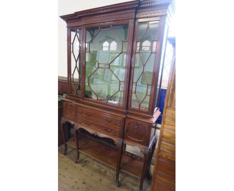 An Edwardian walnut break front display cabinet, having a glazed upper section, with two doors below flanked by two cupboards