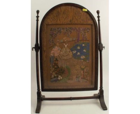 A table top oak swing frame fire screen, with tapestry panel of ladies in a garden, height 23ins