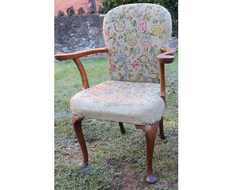 A Queen Anne style walnut open armchair, raised on cabriole front legs, with tapestry back and seat