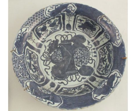 An 18th century Kraak style dish, decorated with central Buddhist emblems and fan shaped panels, within ruyi and diaper work 