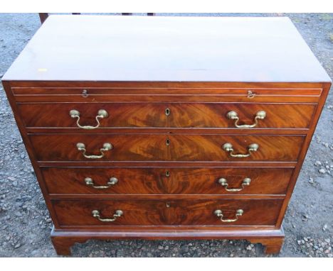 A Georgian mahogany caddy top chest of drawers, fitted with four graduated long drawers below a brushing slide, raised on bra