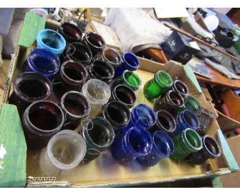 A collection of Victorian coloured glass tea light holders, approximately 30