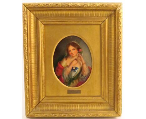 A 19th century oil on board, oval portrait of a woman, inscribed The Locket J Millais to the mount, maximum diameter 6.75ins