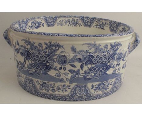 A 19th century Spode blue and white oval foot bath, with moulded body, decorated with urns of flowers, af, diameter 18.5ins, 