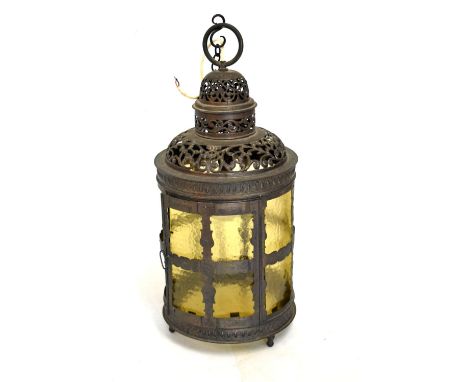 Cylindrical copper finish lantern having pierced decoration and yellow glass shade, 54cm high  