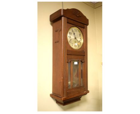 Circa 1920's oak wall timepiece, retailed by Fear Ltd, Bristol Bridge, with silvered Arabic dial over bevelled glazing, 83cm 
