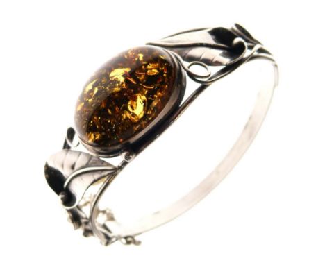 White metal hinged bangle of foliate design with large central amber-coloured cabochon, stamped 925  
