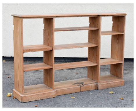 Stripped pine open bookcase of inverted breakfront design, 183cm x 35cm x 120cm high, together with a kitchen preparation tab