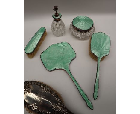 A George V silver and green enamel decorated part dressing table set including a clothes brush, a hair brush hand mirror, ato