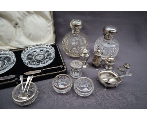 A George V silver topped scent bottle with an embossed globe top, Birmingham, 1910 together with another silver topped and gl