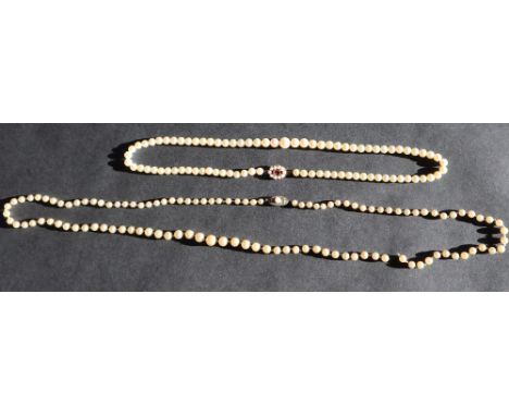 A pearl necklace set with graduated pearls to a 9ct gold garnet and pearl clasp, together with a pair of pearl earrings