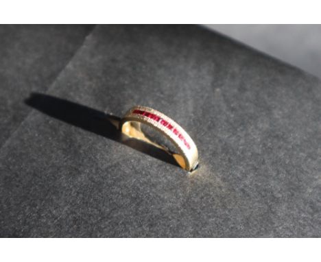 A ruby and diamond half eternity ring set with princess cut rubies and round brilliant cut diamonds to an 18ct gold shank, si