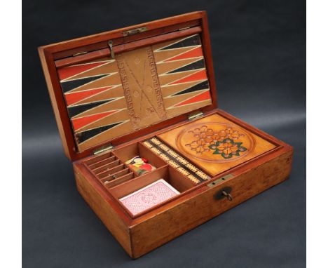 An early 20th century mahogany cased games compendium, with steeple chase board, chess board and backgammon board, with chess