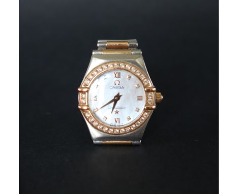 A lady's Omega Constellation wristwatch with a mother of pearl dial, Roman numerals and diamond set hour markers and a diamon