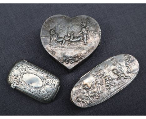 A continental silver heart shaped box decorated with cherubs together with an oval trinket box and a silver vesta case 