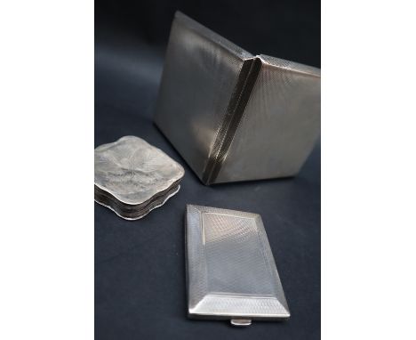 A George V silver cigarette case of square form, with engine turned decoration, London, 1939, together with a silver matchboo