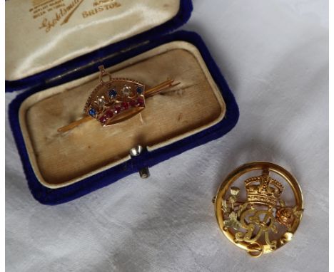 A sapphire diamond and ruby coronet bar brooch set with two rose cut diamonds, three sapphires and six rubies to a yellow met