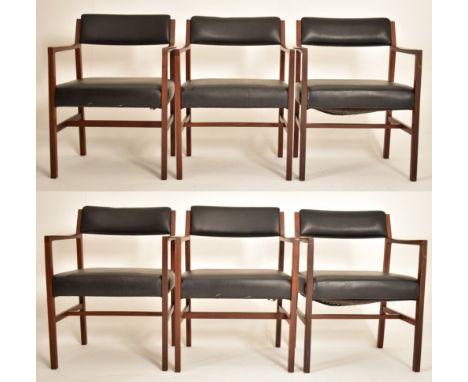 Alfred Cox - A set of six 1970s teak wood dining chairs / office chairs. The chairs having curved arm rests with padded faux 