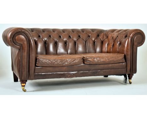 A contemporary brown leather Chesterfield button backed two seater sofa settee. The sofa having a scrolled back and armrests 