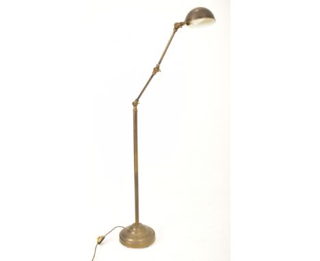 A retro 20th century brassed metal industrial manner floor standard lamp. The light having a dome shaped shade over a three s