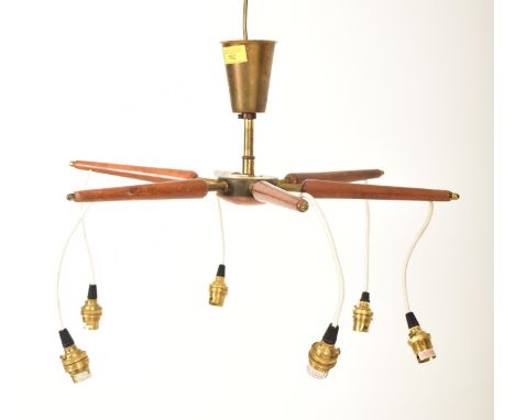 A Danish retro mid 20th century teak &amp; brass six arm ceiling light. The light having a conical brassed metal central colu