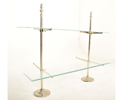 A vintage 20th century Art Deco shop display stand / shelving unit. The display having two chrome upright supports with gradu