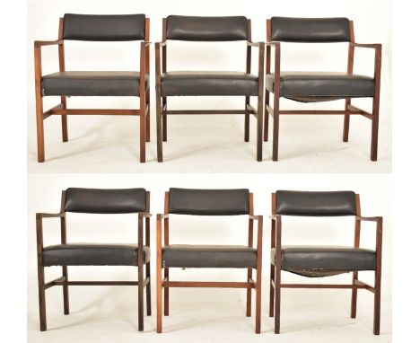 Alfred Cox - A set of six 1970s teak wood dining chairs / office chairs. The chairs having curved arm rests with padded faux 