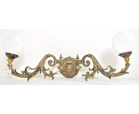 An early 20th century circa 1900s French Art Nouveau&nbsp;cast metal twin arm wall light sconce. The light having a central c
