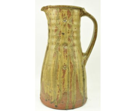 Jim Malone (b. 1946) - A large studio art pottery stoneware single handled jug. The jug having textured &amp; impressed decor