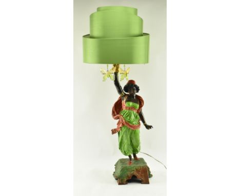 A retro 20th century Blackamoor cast metal table lamp light. The lamp having a drum shaped green shade with steam forming a g