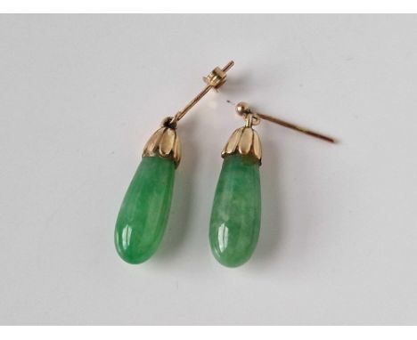 A pair of gold topped jade earrings