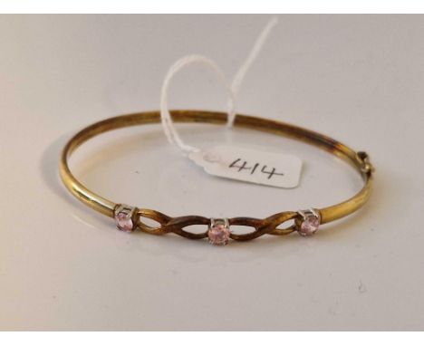 A pink stone set bangle 9ct 3.9 gms 6cm diameter