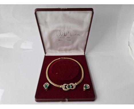 A gold tone multi green and white stone necklace and earrings set boxed