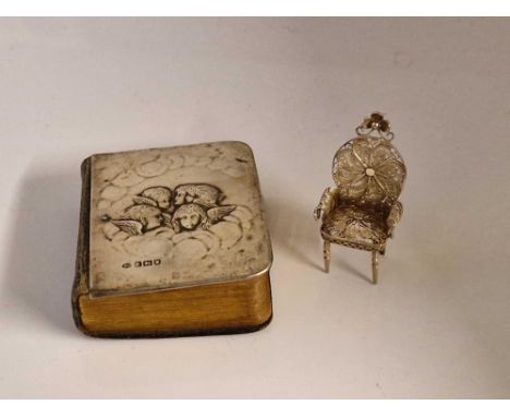 Prayer book embossed with an angels head. London 1904 By W C and a miniature filigree chair.