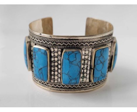 A large wide vintage silver cuff bangle set with turquoise