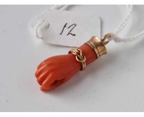 A Victorian gold and coral hand pendant