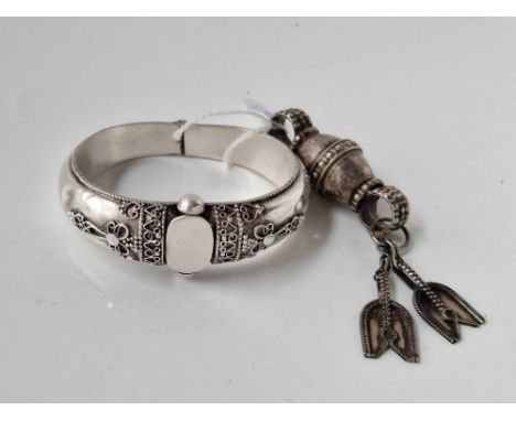 A vintage silver tribal bangle together with silver hand of Fatima pendant